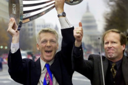 DC United coach Tom Rongen holds the 1999 MLS Championship Cup during the victory parade in downtown Washington Tuesday Nov. 23, 1999, as General Manager Kevin Payne gives a thumbs up. Hundreds gathered at Freedom Plaza to greet the three-time champs, who shut out the LA Galaxy 2-0 Sunday. (AP Photo/Doug Mills)