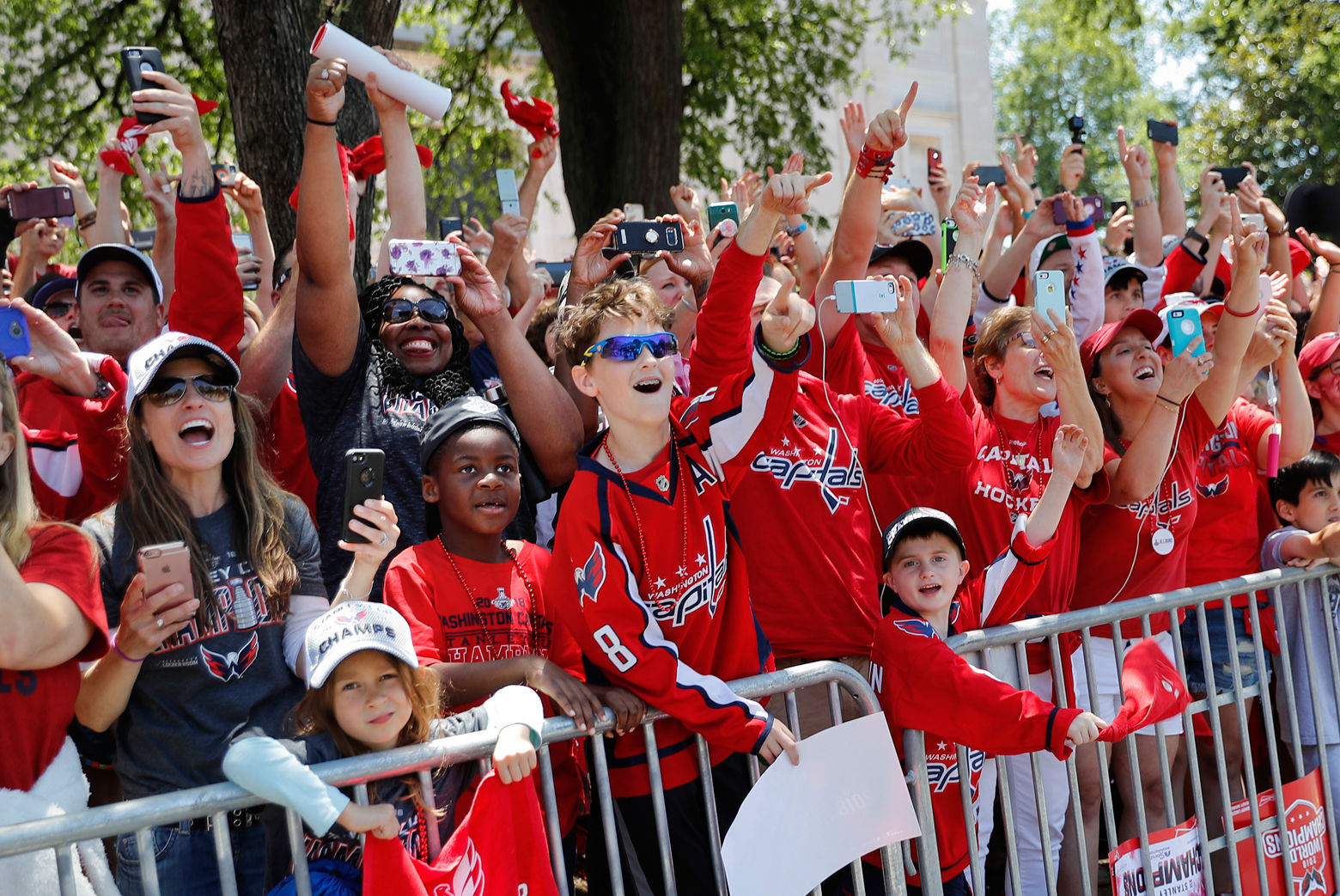 Fans wave as the Capitals drive by. (AP Photo/Pablo Martinez Monsivais)