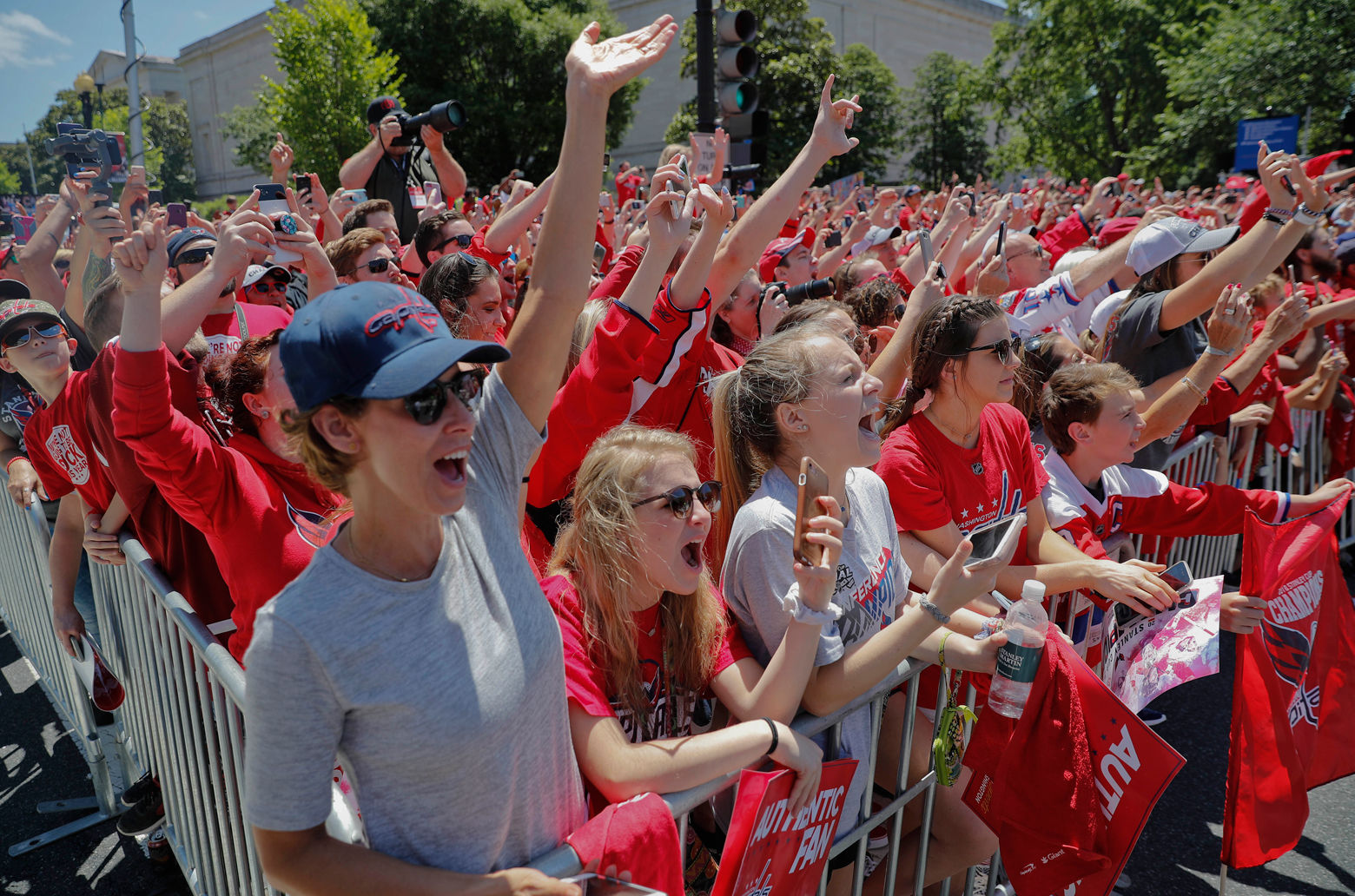 Fans wave as they watch the parade. (AP Photo/Pablo Martinez Monsivais)