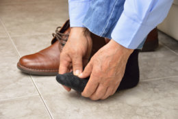 Cropped shot of an unrecognizable man suffering with foot cramp in the room
