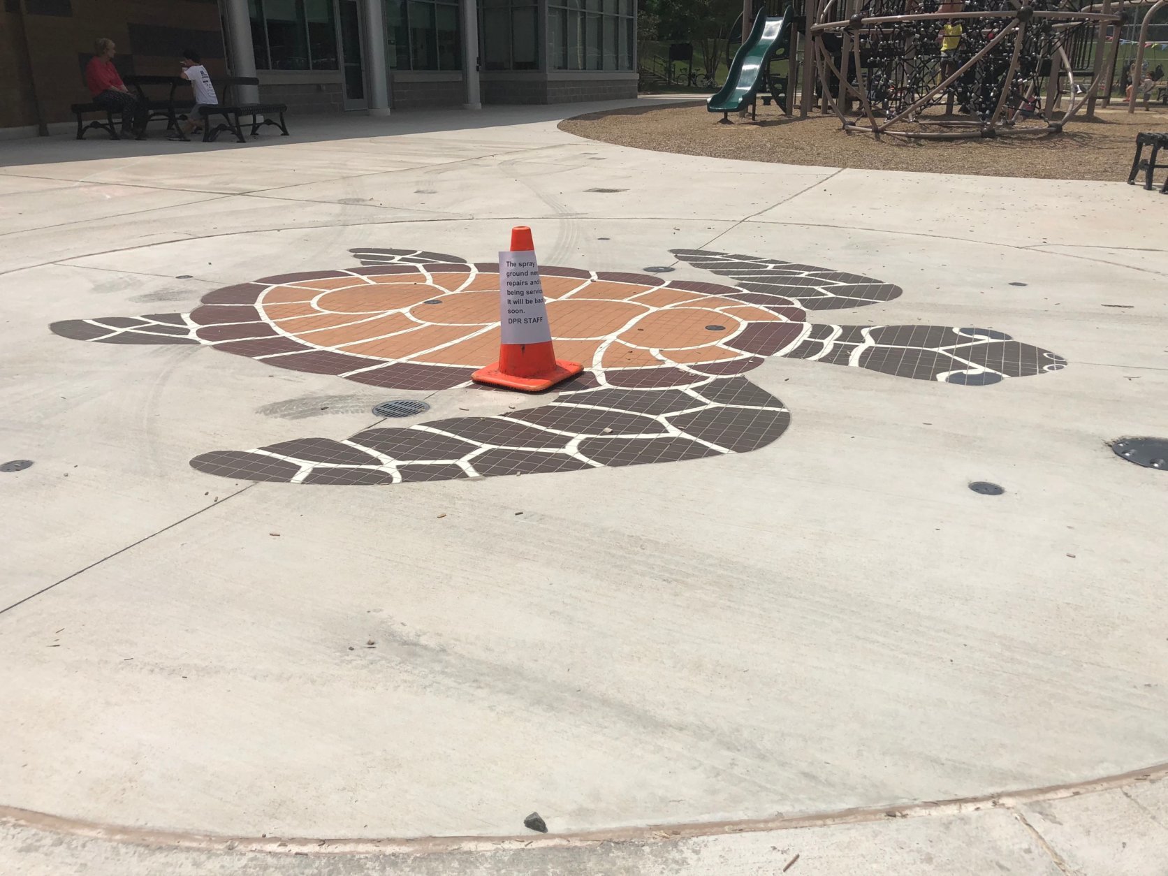 The splash pad, which normally sprays water for children to play in, has been closed while officials try to fix the reports of sewage contamination in the water. (WTOP/Melissa Howell)