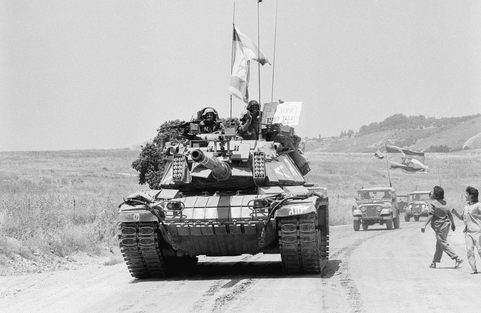 One of the last Israeli tanks to leave south Lebanon driving back into Israel on Monday, June 10, 1985 in Metulla, Israel. It was three years and four days since Israel invaded Lebanon during the Operation Peace for Oalilee. The smiling crewmen on the turret of the American-made Patton tank are holding a sigh; saying in Hebrew Stop', Border is in front of you. (AP Photo/Max Nash)