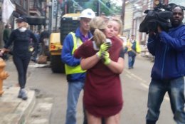 Ellicott City residents hug amid cleanup on Sunday, June 3, 2018. (WTOP/Kathy Stewart)