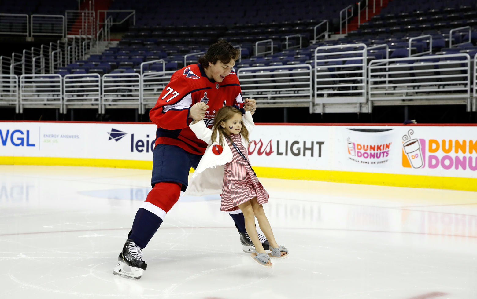 Washington Capitals NHL hockey team right wing T.J. Oshie (77) skates with his daughter Lyla Oshie after the Capitals team picture on the ice at Capital One Arena, Tuesday, June 12. (AP Photo/Alex Brandon)