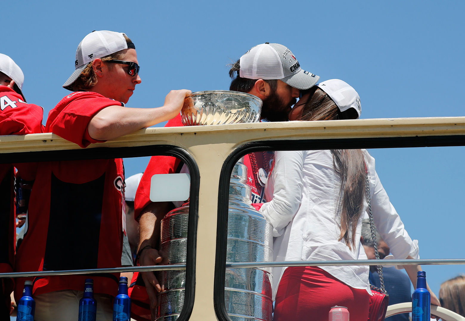 Alex Ovechkin kisses his wife Nastya Ovechkina, right, as they exit the bus during the Stanley Cup victory parade. (AP Photo/Pablo Martinez Monsivais)