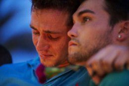 Austin Hagge, left, cries on the shoulder of Austin Matthew, during a candlelight vigil downtown for the victims of a mass shooting at the Pulse nightclub Monday, June 13, 2016, in Orlando, Fla. Hagge and Matthew lost two friends in the shooting. A gunman has killed dozens of people in a massacre at a crowded gay nightclub in Orlando on Sunday, making it the deadliest mass shooting in modern U.S. history. (AP Photo/David Goldman)