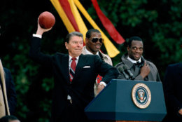 President Reagan readies to throw a football to Washington Redskins' receiver Ricky Sanders during ceremonies honoring the Super Bowl XXII champions at the White House in Washington, D.C., Feb. 4, 1988. The ball was presented to the president by quarterback Doug Williams. The Redskins defeated the Denver Broncos 42-10, at Jack Murphy stadium in San Diego, Calif. (AP Photo/Doug Mills)