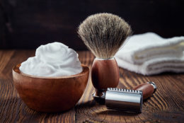 Shaving accessories on wooden background