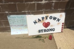 Signs are seen at a memorial outside of the Capital Gazette in Annapolis where five people were killed by a gunman. (WTOP/Mike Murillo)