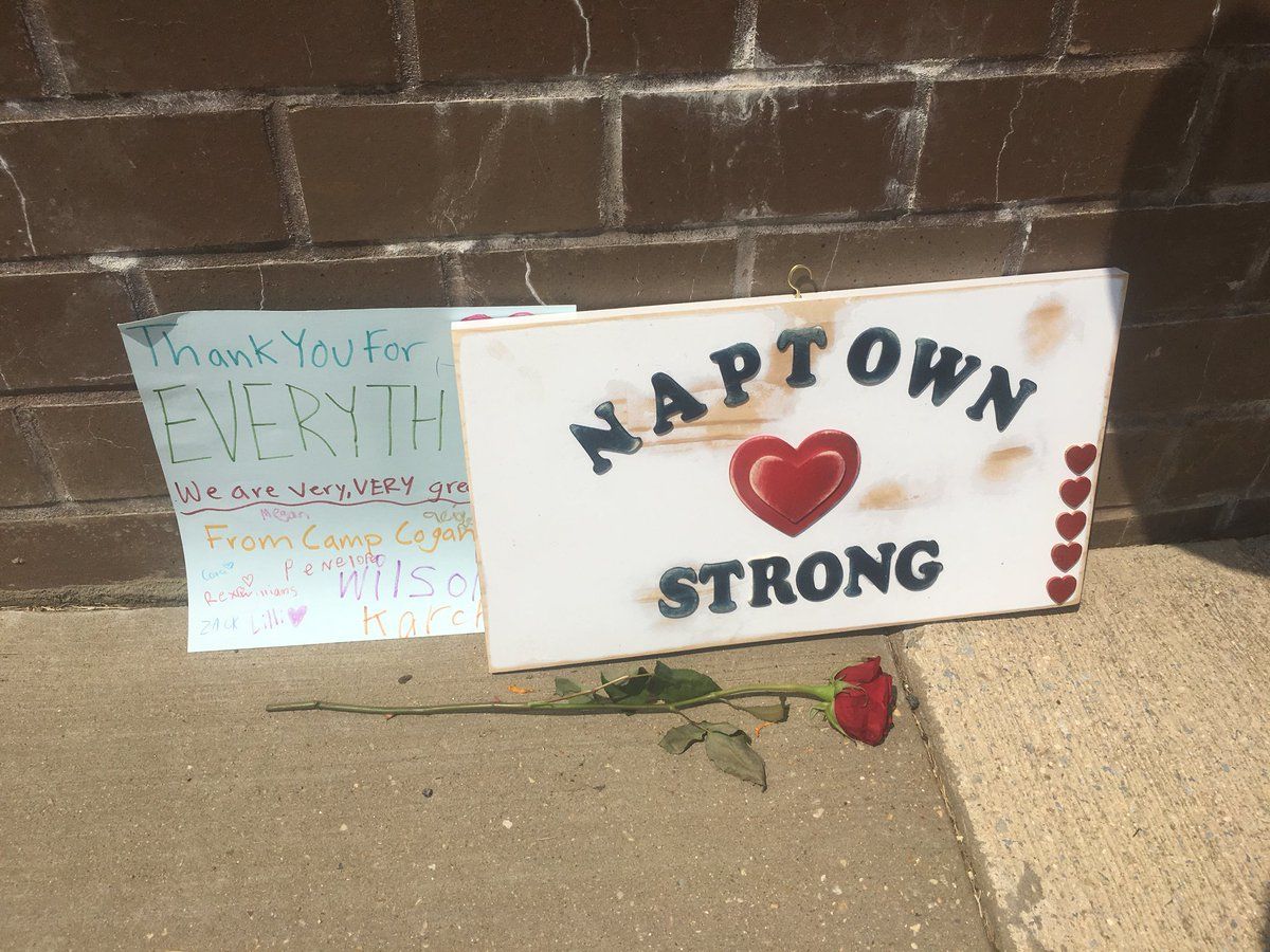 Signs are seen at a memorial outside of the Capital Gazette in Annapolis where five people were killed by a gunman. (WTOP/Mike Murillo)
