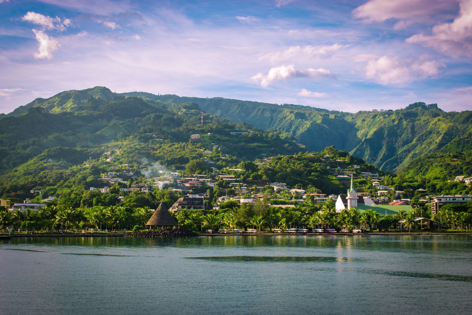 Landscape of Tahiti with mountains and village close to the port of Papeete, French Polynesia. Cruise and honeymoon destination.
