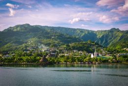 Landscape of Tahiti with mountains and village close to the port of Papeete, French Polynesia. Cruise and honeymoon destination.