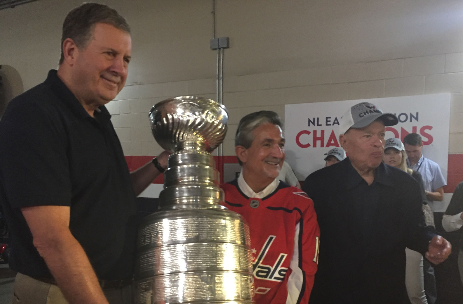 Ted Lerner is seen with Capitals President Dick Patrick and Capitals owner Ted Leonsis with the Stanley Cup at Nationals Park on Saturday, July 9, 2018. (WTOP/Jonathan Warner)