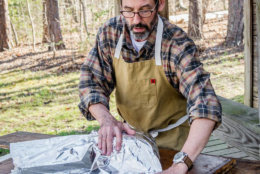 Tuffy Stone demonstrates the "Texas Crutch" method to making ribs on the grill. The key is to wrap the ribs just at the right time to seal in moisture and heat, but prevent burning. (Courtesy Ken Goodman)