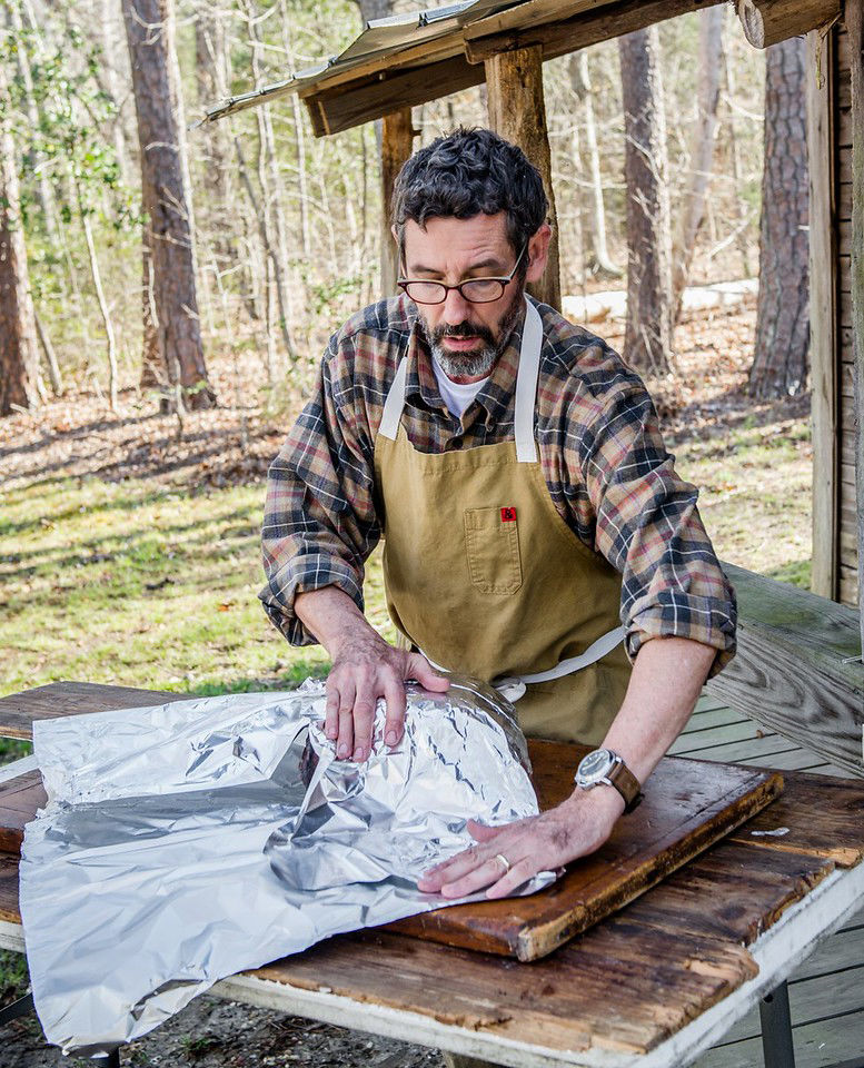 Tuffy Stone demonstrates the "Texas Crutch" method to making ribs on the grill. The key is to wrap the ribs just at the right time to seal in moisture and heat, but prevent burning. (Courtesy Ken Goodman)
