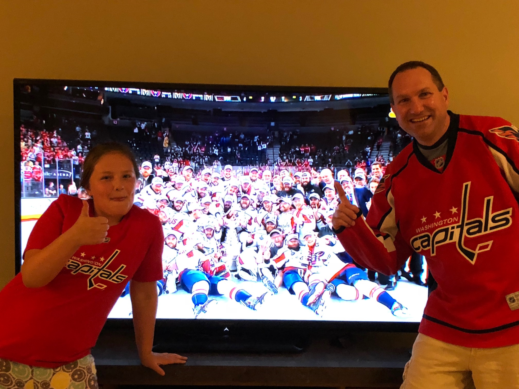 From the comfort of their home, two WTOP listeners join in on the Caps' team photo. (Courtesy WTOP Listeners) 