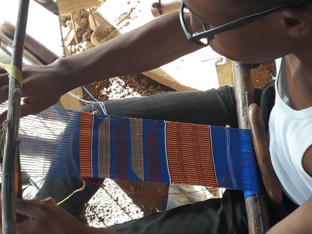 Ghanaian weaver Kofi Asare, son of Kwasi Asare, weaves Kente cloth on a loom. (Kwasi Asare)