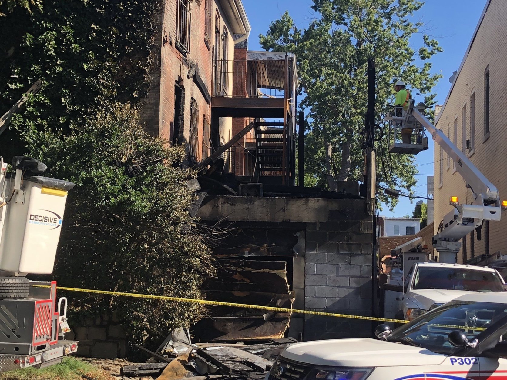 Officials say the fire began on the porch of a row house on 11th street and Columbia Road before spreading to the attached home. (WTOP/Melissa Howell)