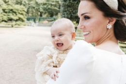 In this Monday, July 9, 2018 photo made available by Kensington Palace, Kate, the Duchess of Cambridge poses for a photo with Prince Louis in the garden of Clarence House, following Prince Louis's baptism at the Chapel Royal, St. James's Palace, in London. (Matt Porteous/Kensington Palace via AP)