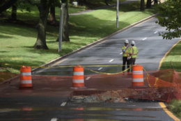 The work to fix the flood-damaged section of Father Hurley Boulevard between Crystal Rock Drive and Middlebrook Road in Germantown, Maryland, continued July 24  despite occasional downpours. (WTOP/Dave Dildine)