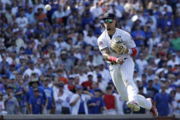 Chicago Cubs' Javier Baez throws out Detroit Tigers' Jose Iglesias to end a baseball game Tuesday, July 3, 2018, in Chicago. The Cubs won 5-3. (AP Photo/Charles Rex Arbogast)