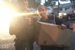 Cpl. Cary (left) with Anna Pence, 19, the college student who orchestrated the osprey rescue. The bird was brought to a rehabilitation center in the cardboard box, pictured. (Courtesy Anna Pence via Facebook)
