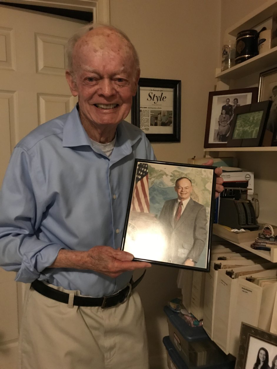 Shea holds a photo of himself taken during his time in the Air Force. (WTOP/Ginger Whitaker)