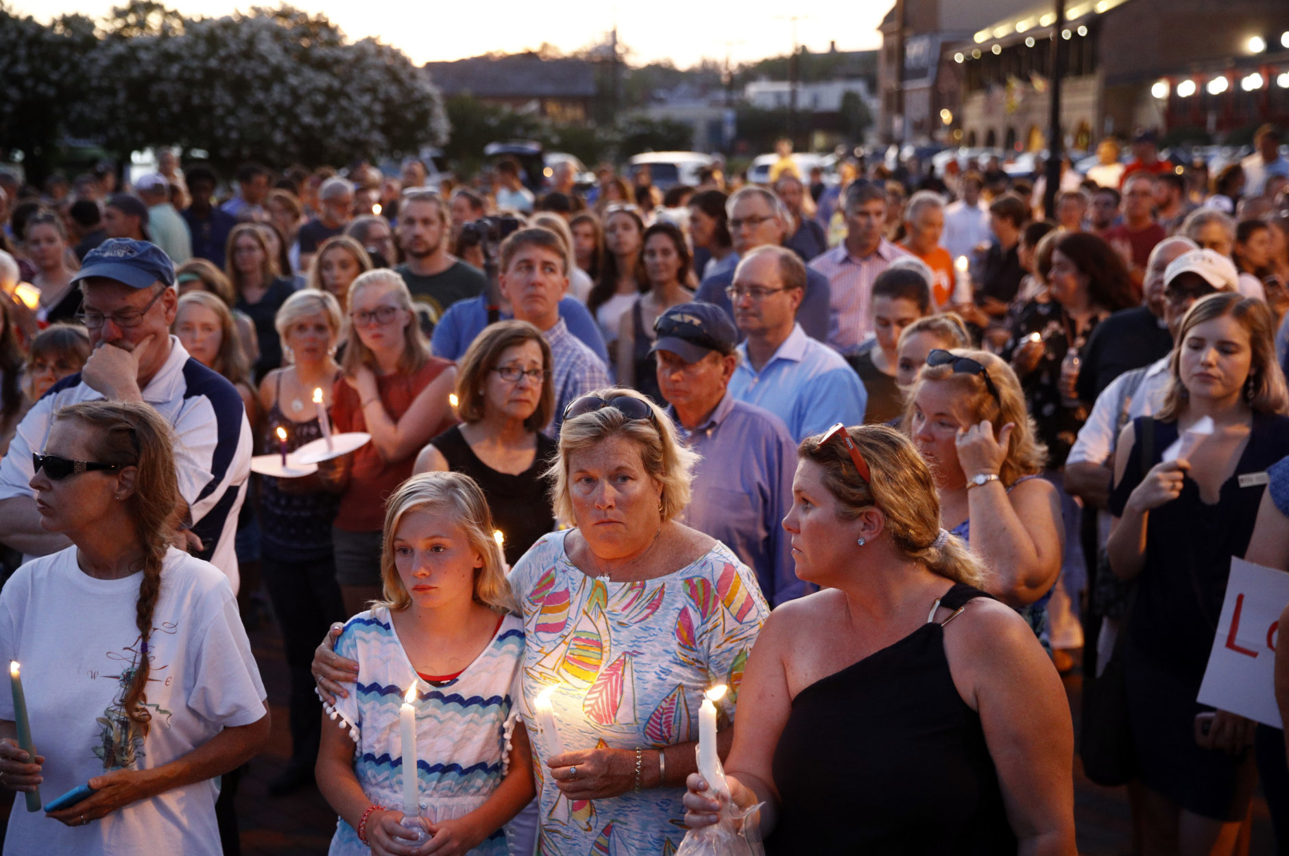Mourners stand in silence during a vigil in response to a shooting at the Capital Gazette newsroom, Friday, June 29, 2018, in Annapolis, Md. Prosecutors say 38-year-old Jarrod W. Ramos opened fire Thursday in the newsroom. (AP Photo/Patrick Semansky)