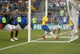 Brazil's Roberto Firmino scores his side's second goal during the round of 16 match between Brazil and Mexico at the 2018 soccer World Cup in the Samara Arena, in Samara, Russia, Monday, July 2, 2018. (AP Photo/Frank Augstein)