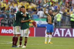 Brazil's Neymar celebrates as Mexico's Miguel Layun and teammates Hirving Lozano embrace at the end of their round of 16 match at the 2018 soccer World Cup in the Samara Arena, in Samara, Russia, Monday, July 2, 2018. Brazil won 2-0. (AP Photo/Eduardo Verdugo)