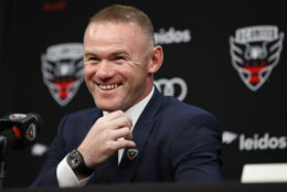 English soccer star Wayne Rooney, the all-time leading scorer for England's national team and Manchester United in the Premier League, smiles during a news conference announcing his signing with MLS team D.C. United, Monday, July 2, 2018, at the Newseum in Washington. (AP Photo/Jacquelyn Martin)