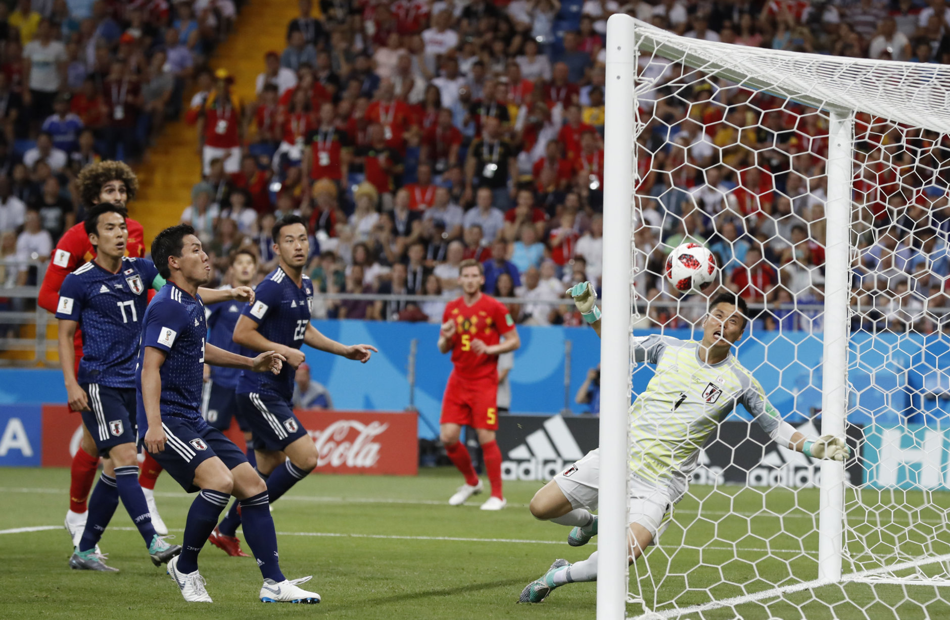 Japan goalkeeper Eiji Kawashima, right, fails to save a ball as Belgium's Jan Vertonghen, center, scores his first side's goal during the round of 16 match between Belgium and Japan at the 2018 soccer World Cup in the Rostov Arena, in Rostov-on-Don, Russia, Monday, July 2, 2018. (AP Photo/Rebecca Blackwell)