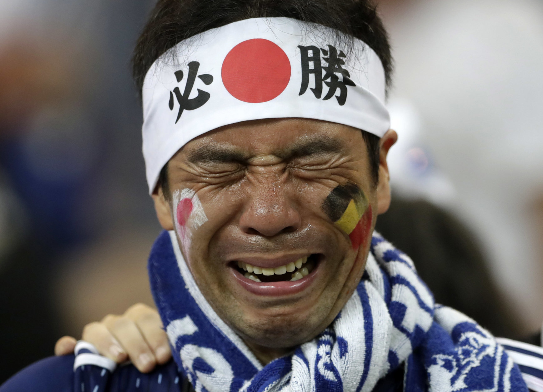 A Japan supporters cries after losing the round of 16 match between Belgium and Japan at the 2018 soccer World Cup in the Rostov Arena, in Rostov-on-Don, Russia, Monday, July 2, 2018. (AP Photo/Petr David Josek)