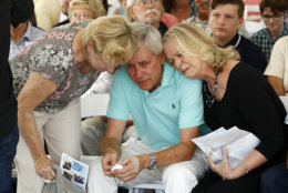 ADDS THE NAME OF THE WOMAN, LEFT - Carl Hiaasen, center, brother of Rob Hiaasen, one of the journalists killed in the shooting at The Capital Gazette newspaper offices, is consoled by his sisters Barb, left, and Judy during a memorial service, Monday, July 2, 2018, in Owings Mills, Md. (AP Photo/Patrick Semansky)
