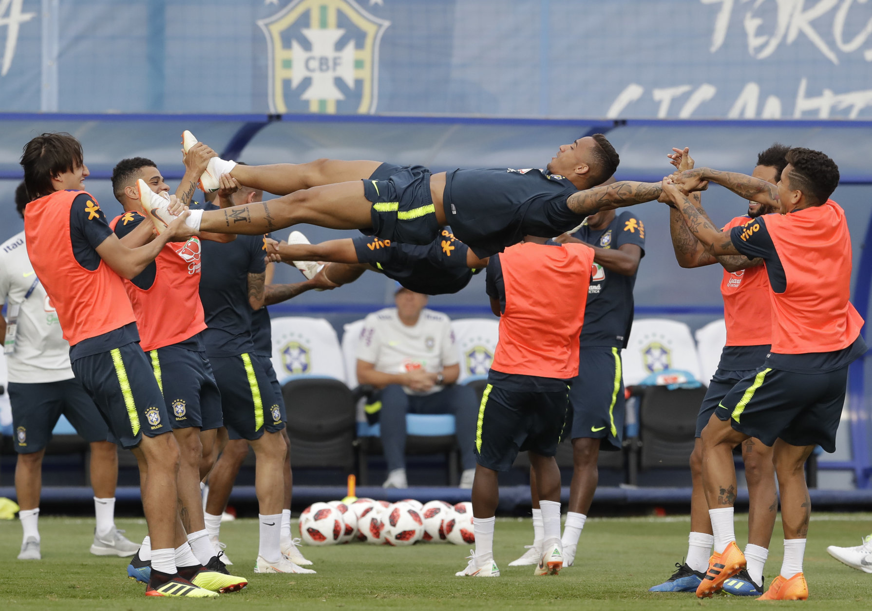 Brazil's players stretch teammate Danilo during a training session, in Sochi, Russia, Tuesday, July 3, 2018. Brazil will face Belgium on July 6 in the quarterfinals for the soccer World Cup. (AP Photo/Andre Penner)