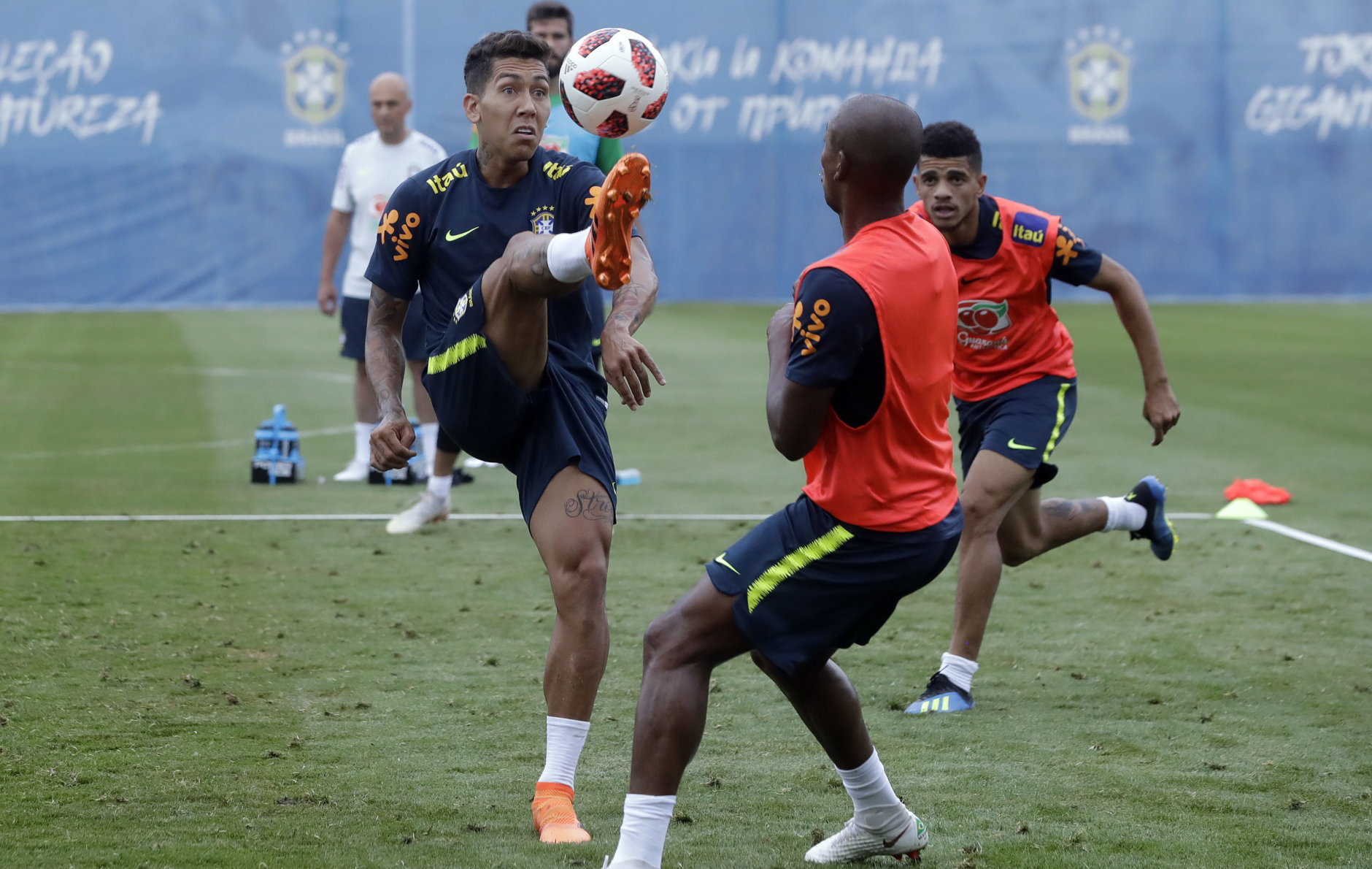 Brazil's Roberto Firmino, left, Fernandinho, center, and Taison practice during a training session, in Sochi, Russia, Tuesday, July 3, 2018. Brazil will face Belgium on July 6 in the quarterfinals for the soccer World Cup. (AP Photo/Andre Penner)