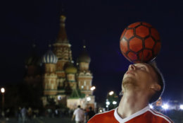 A Russian soccer fan shows off his ball skills as he plays with tourists and soccer fans in Red Square during the 2018 soccer World Cup in Moscow, Russia, Tuesday, July 3, 2018. (AP Photo/Hassan Ammar)