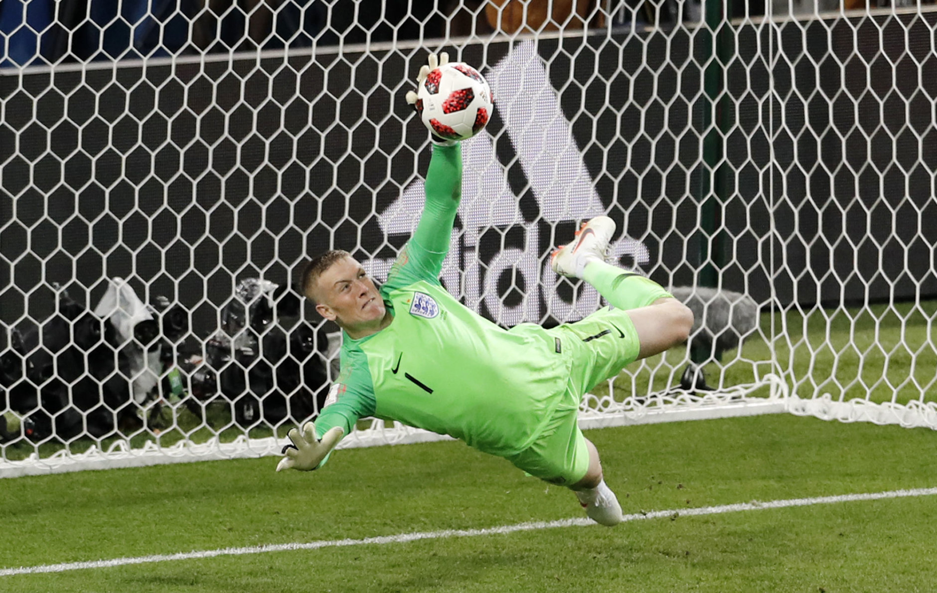 England goalkeeper Jordan Pickford stops a penalty shot from Colombia's Carlos Bacca during the round of 16 match between Colombia and England at the 2018 soccer World Cup in the Spartak Stadium, in Moscow, Russia, Tuesday, July 3, 2018. (AP Photo/Antonio Calanni)