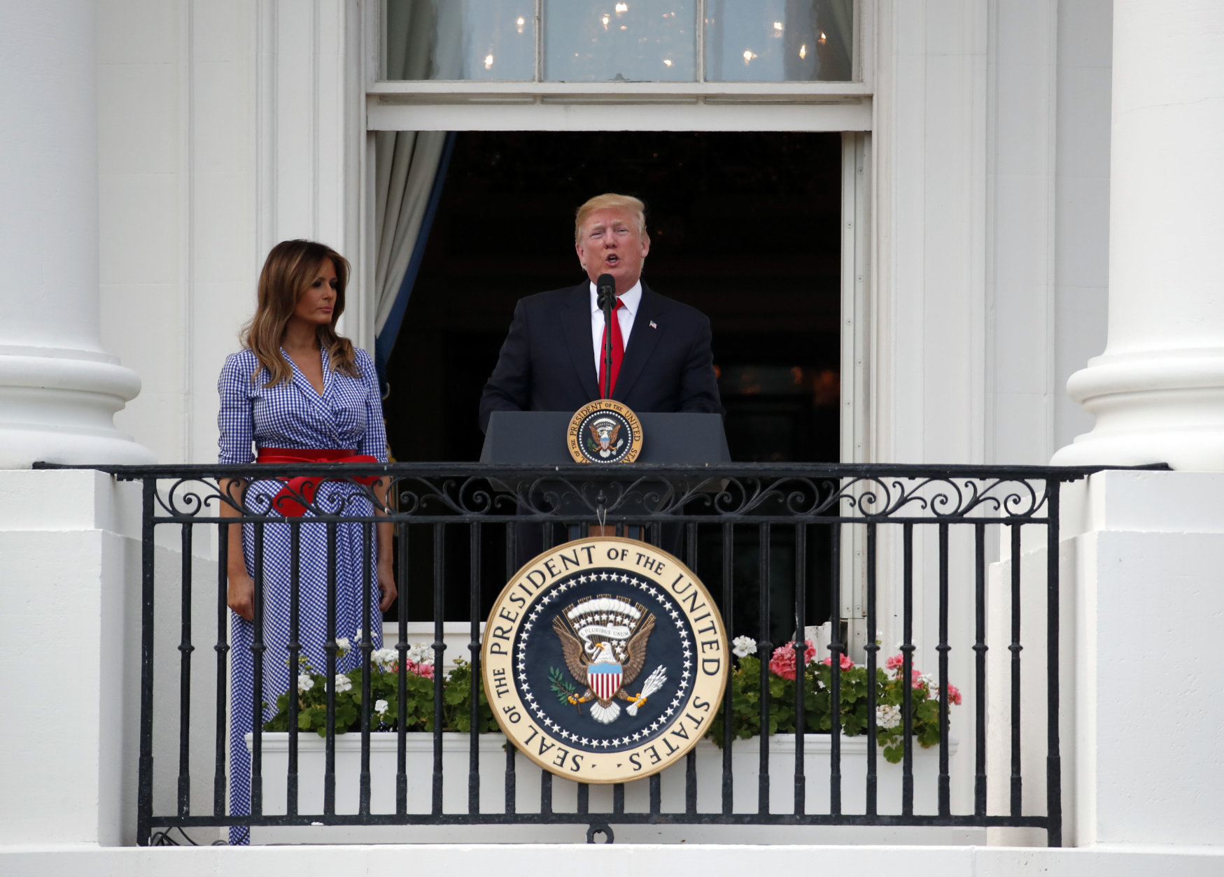 President Donald Trump speaks, accompanied by first lady Melania Trump, during an afternoon picnic for military families on the South Lawn of the White House, Wednesday, July 4, 2018, in Washington. (AP Photo/Alex Brandon)