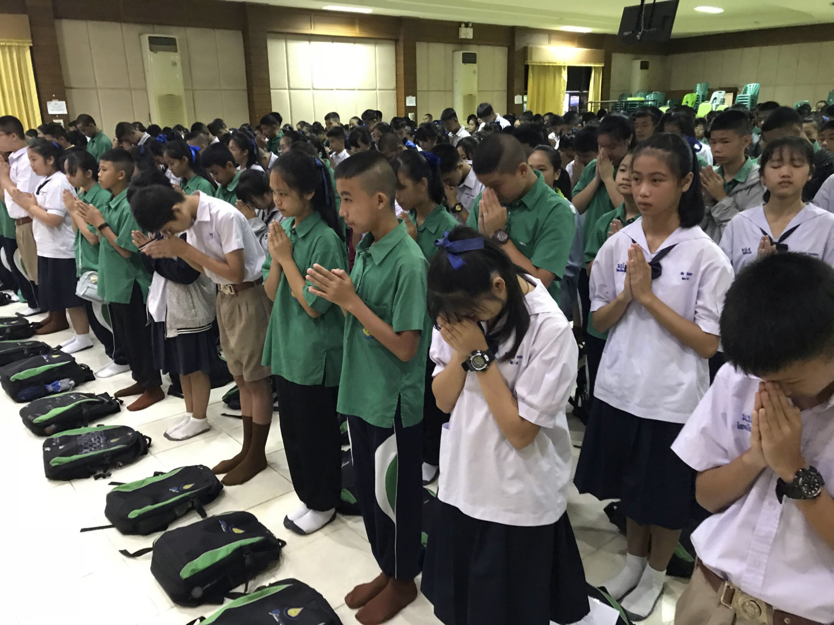 Students pray at Maesaiprasitsart school where six out of the rescued 12 boys study as they cheer the successful rescue in the Mae Sai district in Chiang Rai province, northern Thailand, Wednesday, July 11, 2018. A daring rescue mission in the treacherous confines of a flooded cave in northern Thailand has saved all 12 boys and their soccer coach who were trapped deep within the labyrinth, ending a grueling 18-day ordeal that claimed the life of an experienced volunteer diver and riveted people around the world. (AP Photo/Johnson Lai)