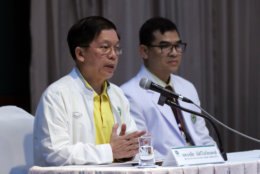 Thongchai Lertwilairatanapong, a public health inspector, left, speaks during a press conference at a hospital in Chiang Rai province, northern Thailand, Wednesday, July 11, 2018. Thongchai said the soccer teammates rescued from a flooded cave lost weight during their two-week ordeal but had water while they were trapped and are in good health. (AP Photo/Vincent Thian)