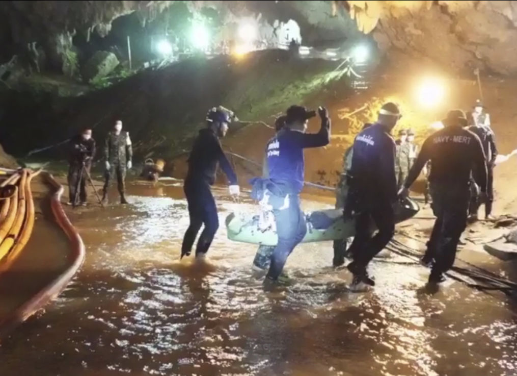 This undated from video released via the Thai NavySEAL Facebook Page on Wednesday, July 11, 2018, shows rescuers hold an evacuated boy inside the Tham Luang Nang Non cave in Mae Sai, Chiang Rai province, in northern Thailand. A daring rescue mission in the treacherous confines of a flooded cave in northern Thailand has saved all 12 boys and their soccer coach who were trapped deep within the labyrinth, ending a grueling 18-day ordeal that claimed the life of an experienced volunteer diver and riveted people around the world. (Thai NavySEAL Facebook Page via AP)
