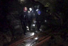 This undated photo from video released via the Thai NavySEAL Facebook Page on Wednesday, July 11, 2018, shows rescuers hold an evacuated boy inside the Tham Luang Nang Non cave in Mae Sai, Chiang Rai province, in northern Thailand. A daring rescue mission in the treacherous confines of a flooded cave in northern Thailand has saved all 12 boys and their soccer coach who were trapped deep within the labyrinth, ending a grueling 18-day ordeal that claimed the life of an experienced volunteer diver and riveted people around the world. (Thai NavySEAL Facebook Page via AP)