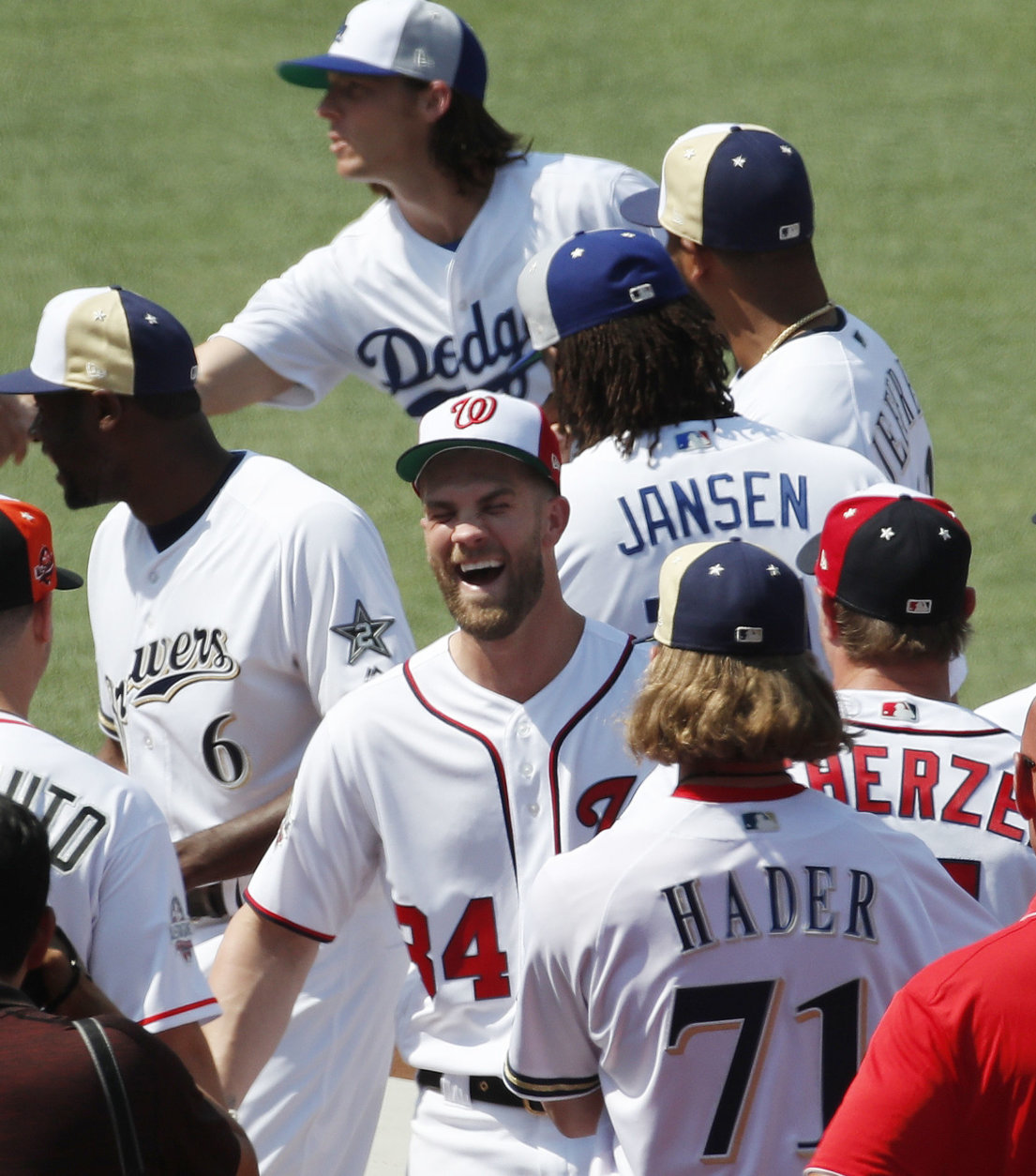National League, Washington Nationals Bryce Harper, center, smiles as players mingle during a team photo, Monday, July 16, 2018, at Nationals Park, in Washington. The the 89th MLB baseball All-Star Game will be played Tuesday. (AP Photo/Alex Brandon)