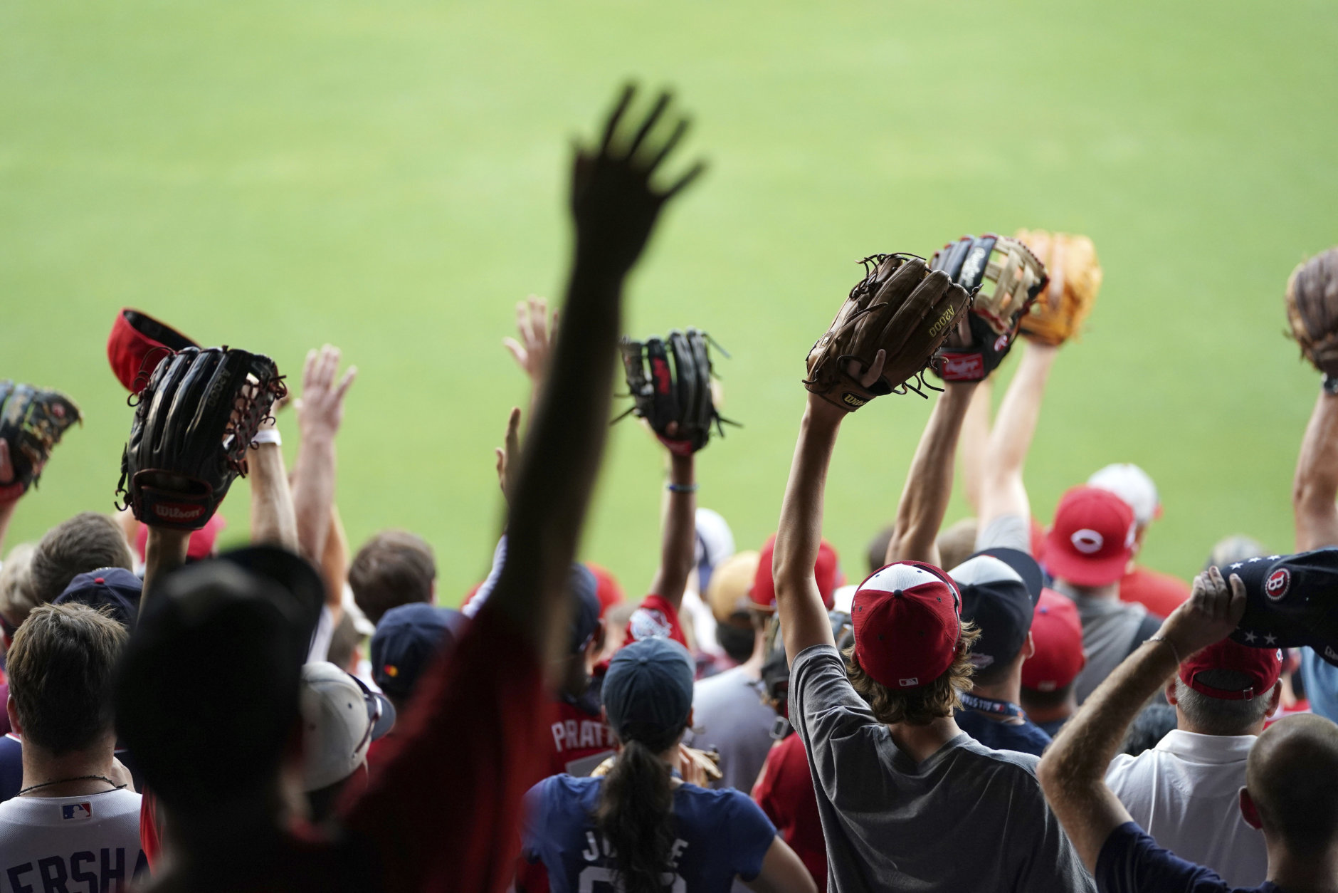 Fans vies for a thrown baseball ahead of the All-Star Home Run Derby Baseball event, Monday, July 16, 2018, at Nationals Park, Washington. The 89th MLB baseball All-Star Game will be played Tuesday. (AP Photo/Carolyn Kaster)