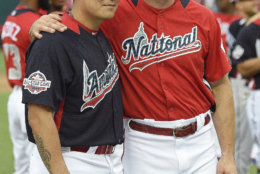 National League, Colorado Rockies Charlie Blackmon, right, embraces American League, Texas Rangers outfielder Shin-Soo Choo ahead of the All-Star Home Run Derby Baseball event, Monday, July 16, 2018, at Nationals Park, in Washington. The 89th MLB baseball All-Star Game will be played Tuesday. (AP Photo/Nick Wass)