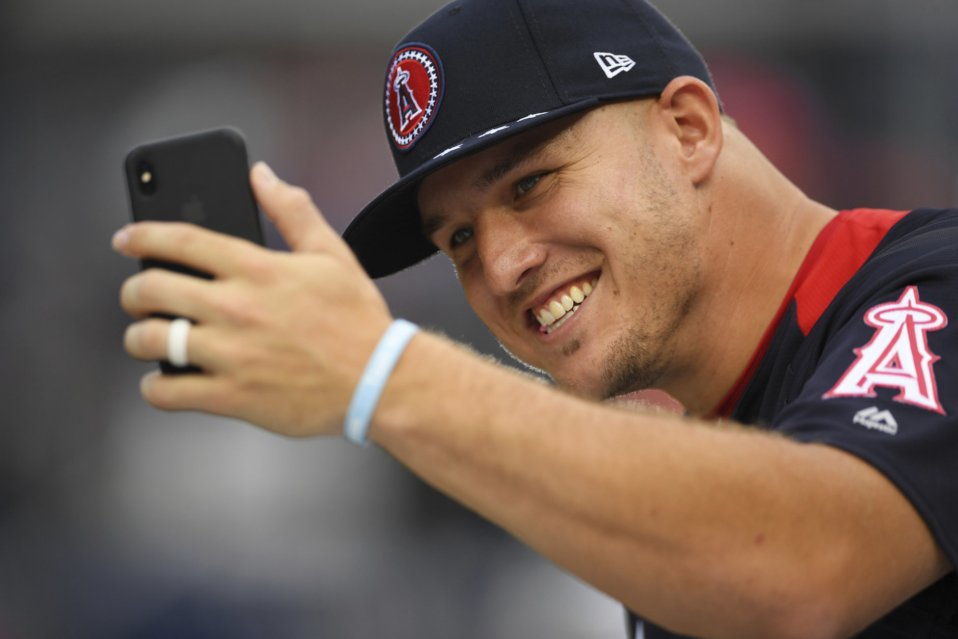 American League, Los Angeles Angels outfielder Mike Trout takes a photo on the field ahead of the All-Star Home Run Derby Baseball event, Monday, July 16, 2018, at Nationals Park, in Washington. The 89th MLB baseball All-Star Game will be played Tuesday. (AP Photo/Patrick Semansky)