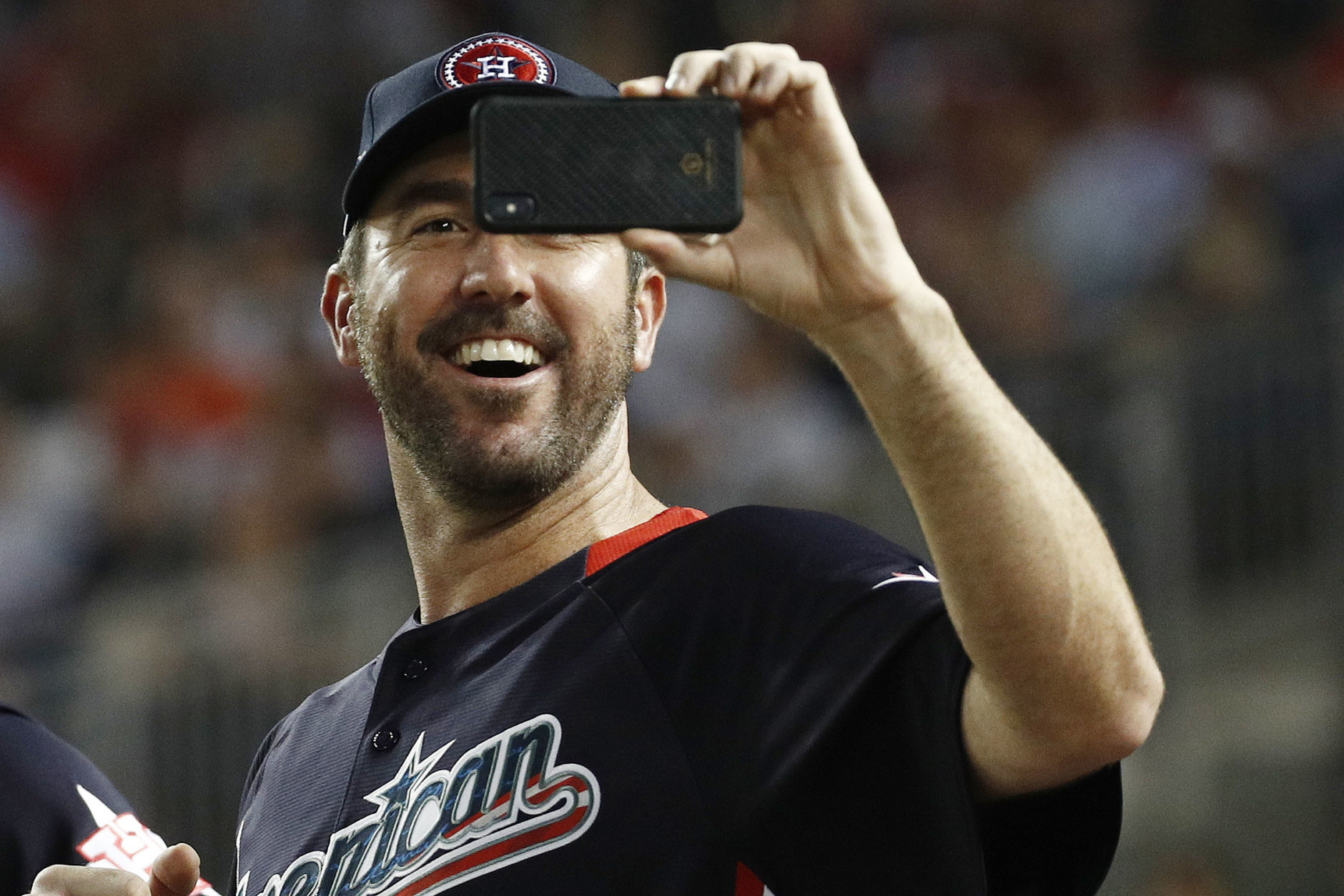 American League, Boston Red Sox pitcher Justin Verlander (35) shoots pictures during the MLB Home Run Derby, at Nationals Park, Monday, July 16, 2018 in Washington. The 89th MLB baseball All-Star Game will be played Tuesday. (AP Photo/Patrick Semansky)