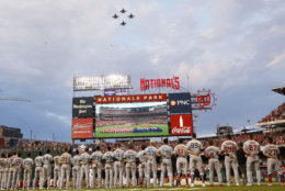 American League players watch the fly over during the Major League Baseball All-star Game, Tuesday, July 17, 2018 in Washington. (AP Photo/Patrick Semansky)