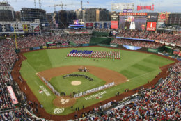 A choir moves on the field before the 89th MLB baseball All-Star Game, Tuesday, July 17, 2018, at Nationals Park, in Washington. (AP Photo/Susan Walsh)